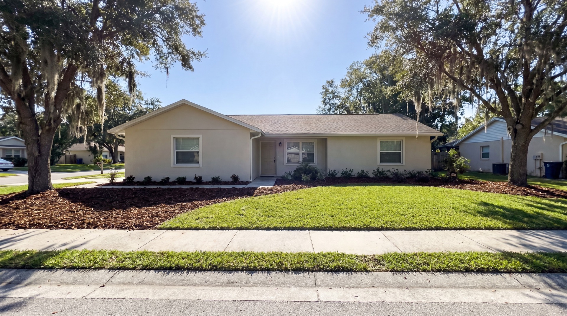 Full front yard mulch installation under oak trees in Orlando neighborhood